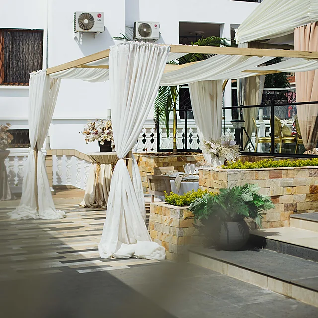 Romantic ceremonial wedding arch draped with bespoke floral installations